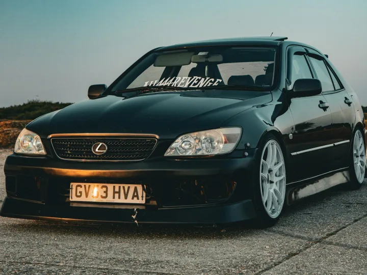 A customized black Lexus sports car parked outdoor