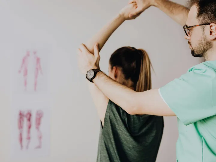 Bearded chiropractor in eyeglasses and wristwatch 