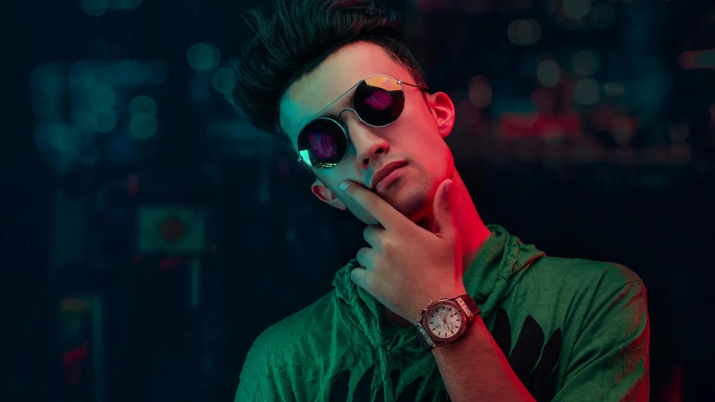Portrait of a young man in sunglasses and neon
